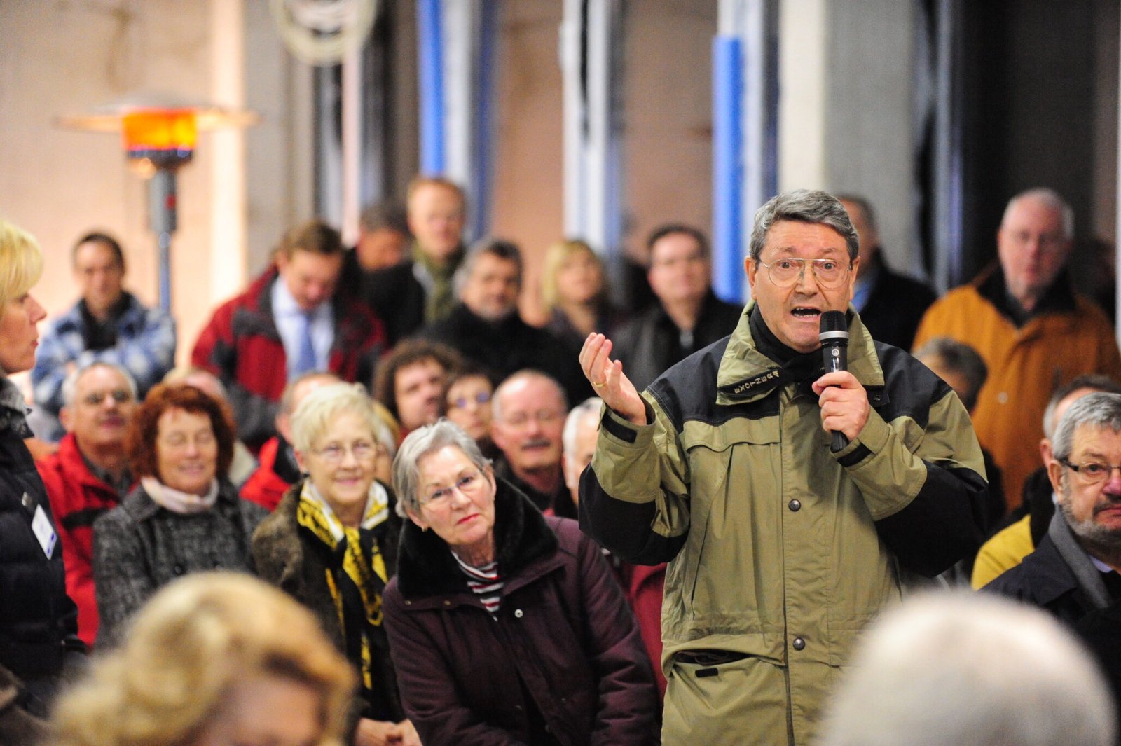 A man speaks at a community gathering